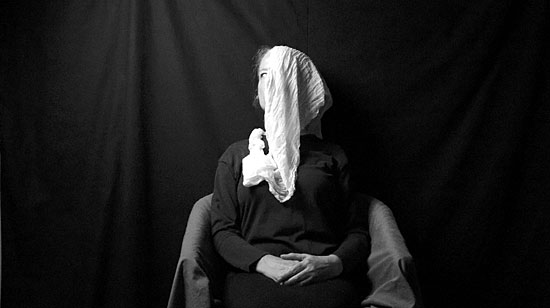 Still image of a seated woman from the porous body film